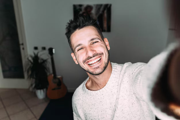 files/joven-tomando-selfie-casa-foto-chico-guapo-sala-estar-disfrutando-fin-semana-hombre-vestido-informal-videollamada-riendose-camara_169160-750.avif